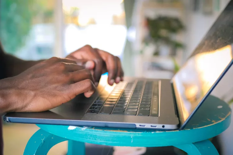 To hender som skriver på et laptop-tastatur.